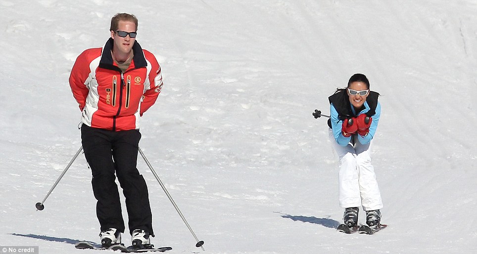 Pippa and George Percy race down the slopes together outside the villa on the Middleton family skiing trip